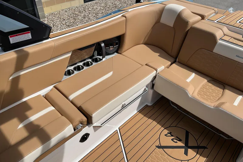 Slide: The Image of Luxurious interior of 2025 MasterCraft X24 boat with tan leather seating and cup holders. - 13