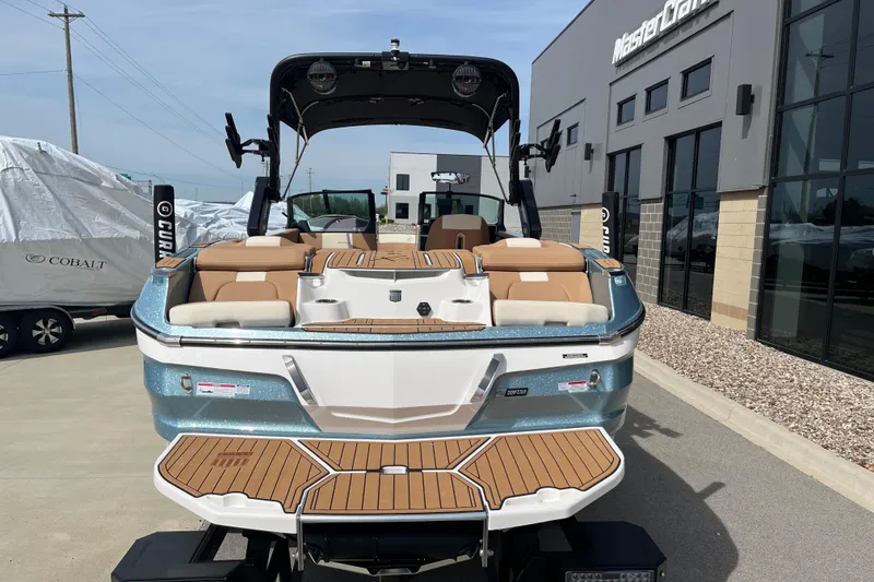 Slide: The Image of 2025 MasterCraft X24 boat displayed outside dealership, showcasing sleek design and spacious seating. - 6