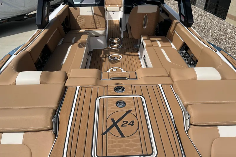 Slide: The Image of 2025 MasterCraft X24 boat interior with tan leather seating and sleek design. - 7
