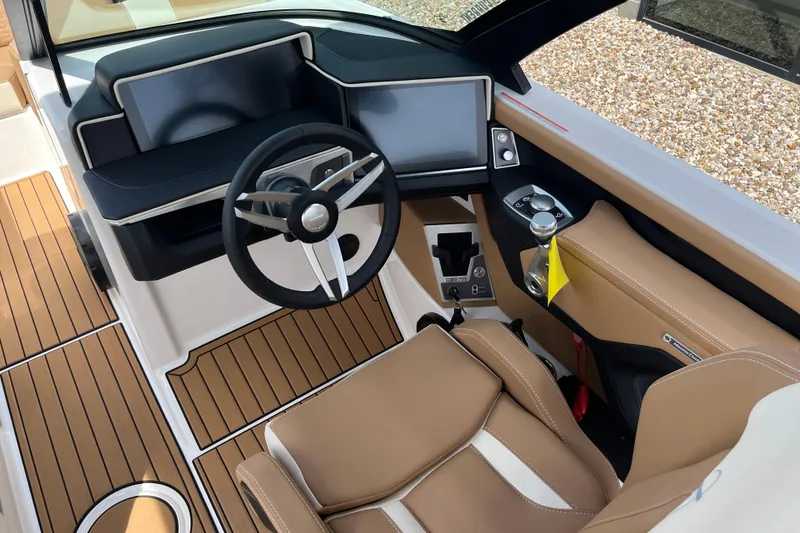 Slide: The Image of 2025 MasterCraft X24 boat cockpit with modern steering and dashboard design. - 8