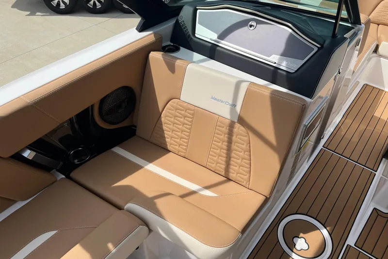 Slide: The Image of 2025 MasterCraft X24 boat interior with tan leather seating and teak-style flooring. - 9