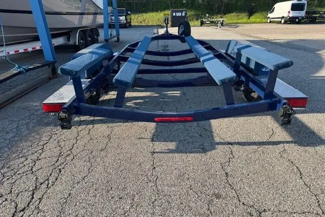 Slide: The Image of Trailer for 2024 Crownline 240 SS boat, parked on a paved lot. - 2