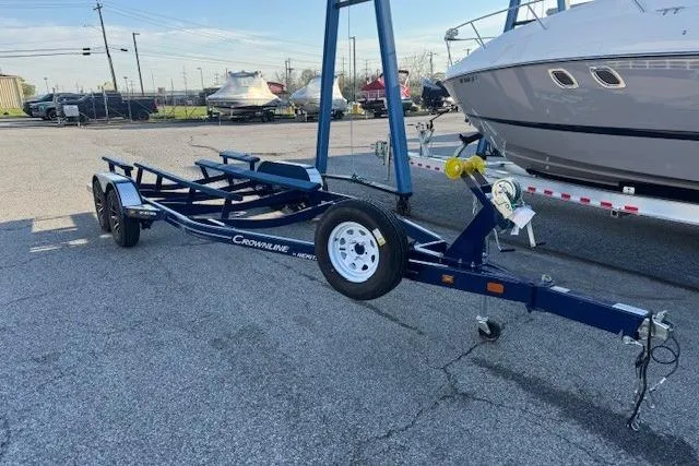 Slide: The Image of Trailer for 2024 Crownline 240 SS boat, parked in a marina setting. - 6