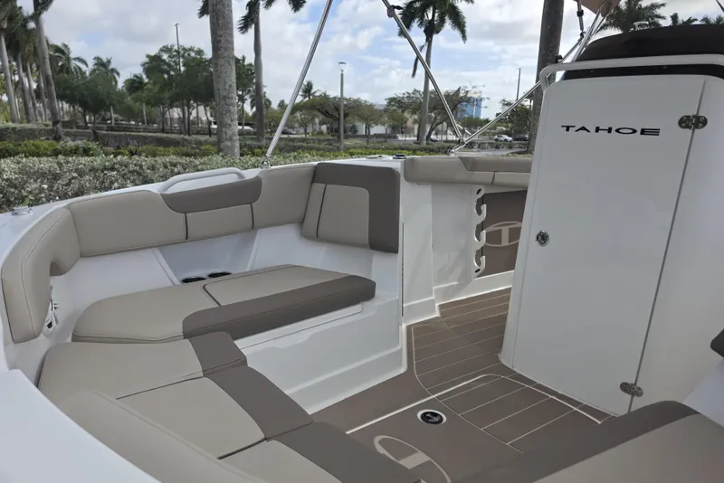 Slide: The Image of 2026 Tahoe 2150 CC boat interior with beige seating and sleek design. - 13