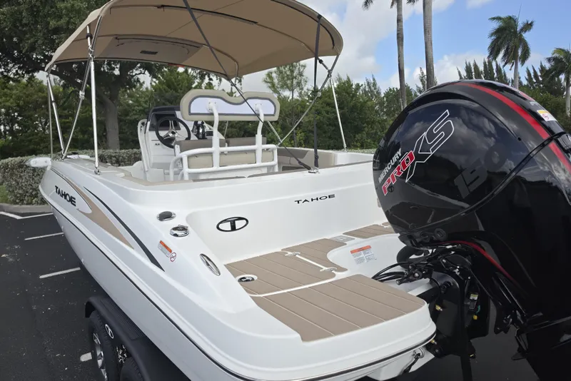 Slide: The Image of 2026 Tahoe 2150 CC boat with Mercury Pro XS engine, parked outdoors under a canopy. - 14