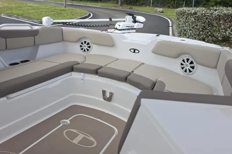 Slide: The Image of 2026 Tahoe 2150 CC boat interior with cushioned seating and speakers. - 15