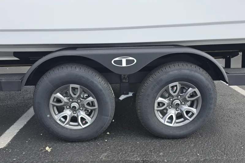 Slide: The Image of Trailer wheels of a 2026 Tahoe 2150 CC boat on asphalt. - 17