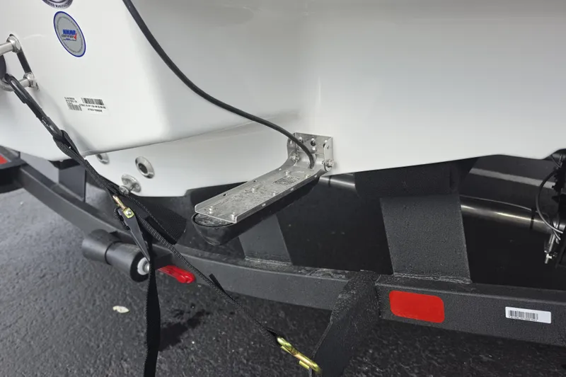 Slide: The Image of 2026 Tahoe 2150 CC boat on trailer, showing rear step and securing straps. - 19