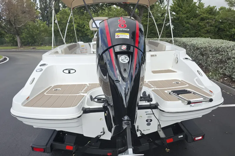Slide: The Image of 2026 Tahoe 2150 CC boat with powerful outboard motor, parked outdoors. - 21