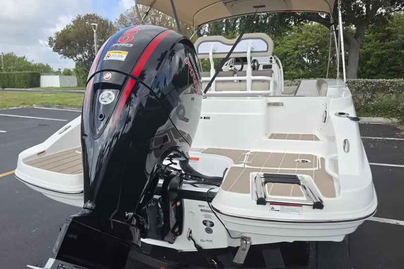 Slide: The Image of 2026 Tahoe 2150 CC boat with powerful outboard motor in a parking lot. - 23
