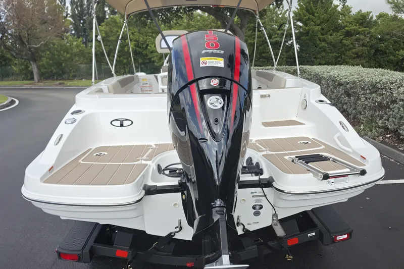 Slide: The Image of 2026 Tahoe 2150 CC boat with powerful outboard motor, parked on a paved surface. - 24