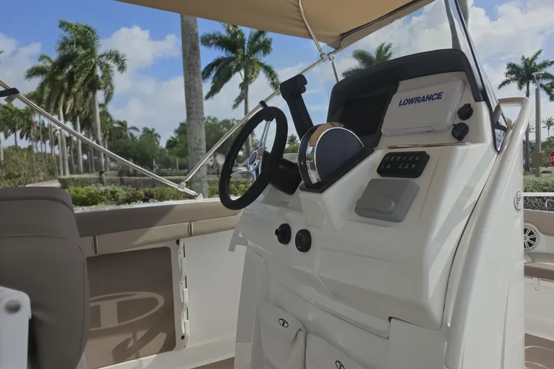Slide: The Image of 2026 Tahoe 2150 CC boat dashboard with steering wheel and navigation system. - 4