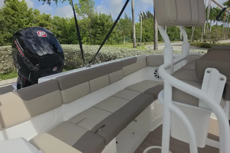Slide: The Image of 2026 Tahoe 2150 CC boat interior with seating and powerful outboard motor. - 6