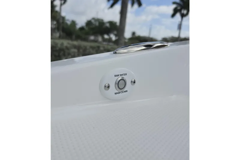 Slide: The Image of 2026 Tahoe 2150 CC boat raw water washdown feature with outdoor background. - 8