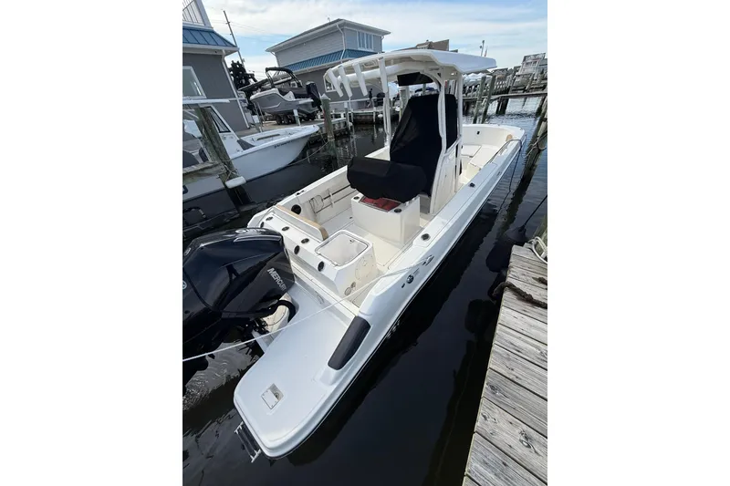 Slide: The Image of 2023 Bayliner Trophy T24CC boat docked at a marina, featuring a sleek design. - 5