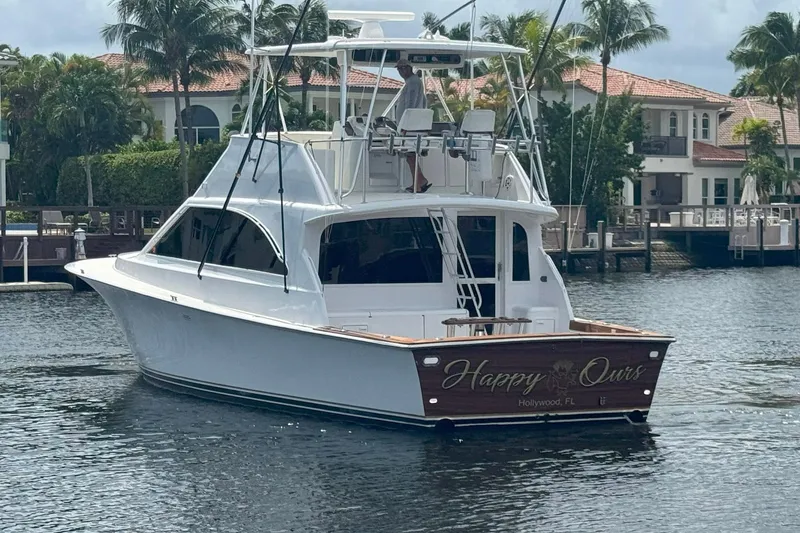 Slide: The Image of 1997 Ocean Yachts 48 Super Sport boat docked near waterfront homes. - 1
