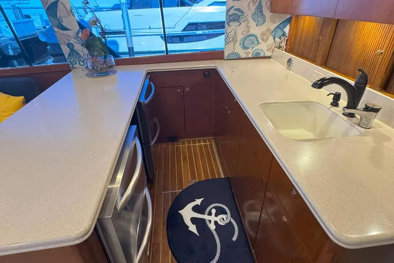 Slide: The Image of 1997 Ocean Yachts 48 Super Sport kitchen with modern appliances and nautical decor. - 13