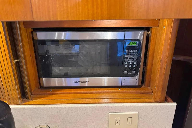 Slide: The Image of Microwave in 1997 Ocean Yachts 48 Super Sport kitchen, wooden cabinetry. - 14