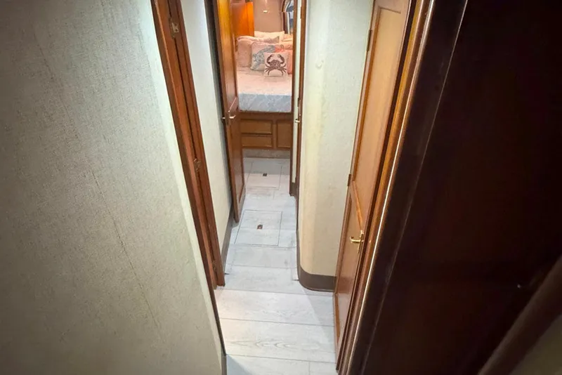 Slide: The Image of Hallway inside 1997 Ocean Yachts 48 Super Sport, leading to a cozy bedroom. - 16