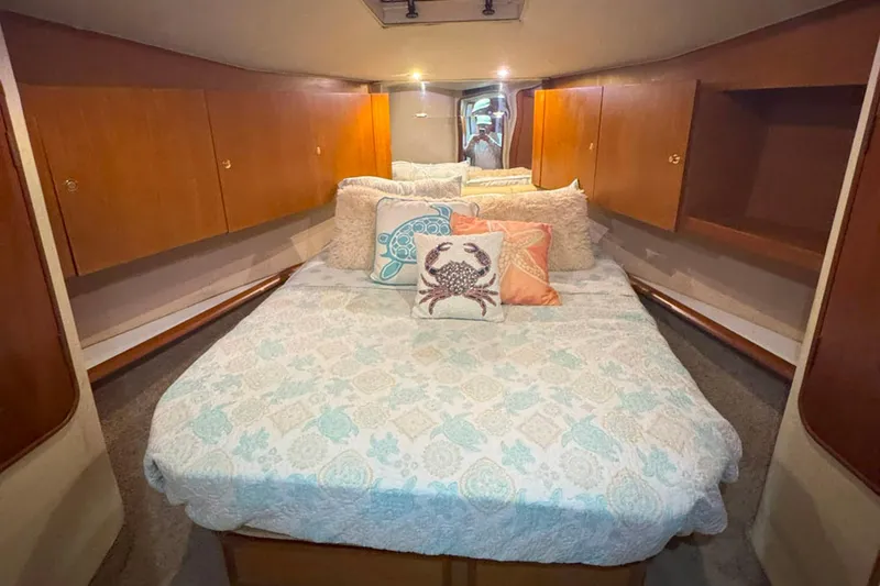 Slide: The Image of Luxurious bedroom in 1997 Ocean Yachts 48 Super Sport with cozy bedding and wooden cabinets. - 17