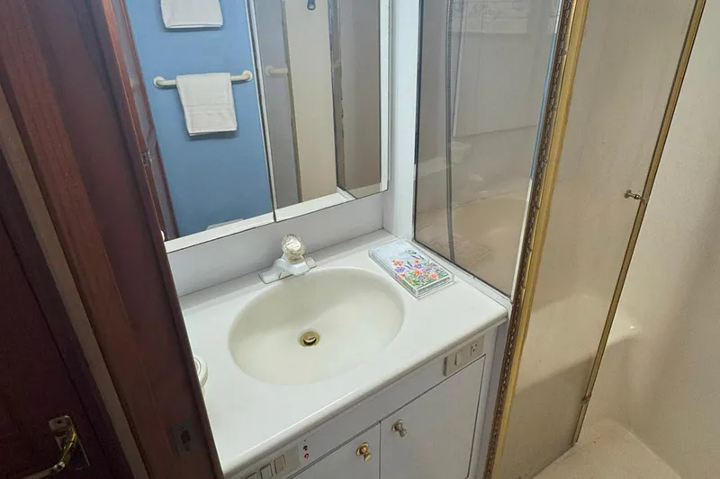 Slide: The Image of Bathroom vanity in 1997 Ocean Yachts 48 Super Sport, featuring sink and mirror. - 19