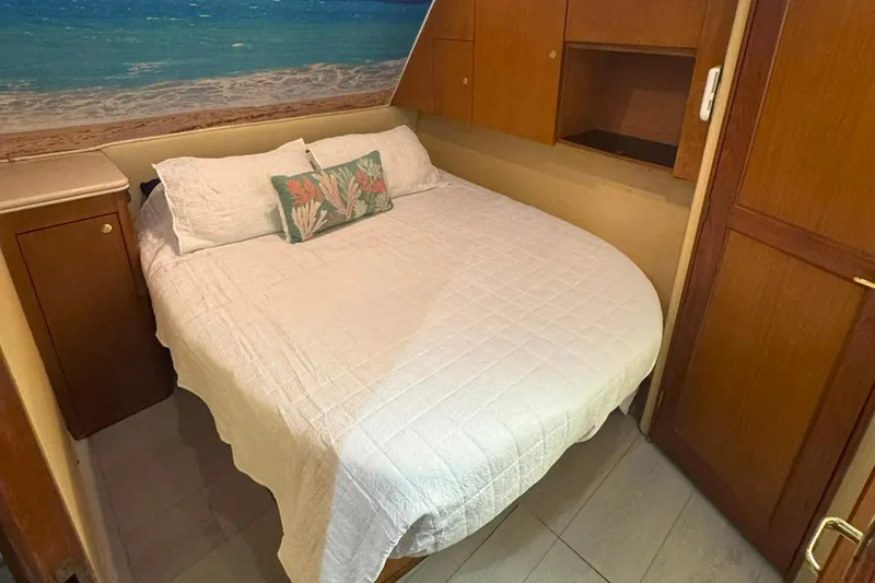 Slide: The Image of Cozy bedroom in 1997 Ocean Yachts 48 Super Sport with beach-themed decor. - 20
