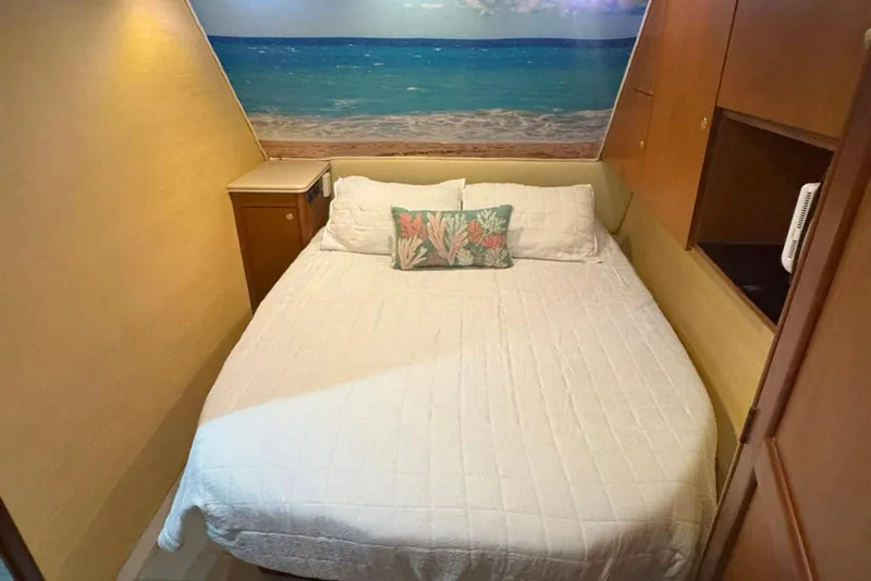 Slide: The Image of Cozy bedroom in 1997 Ocean Yachts 48 Super Sport with beach-themed decor. - 21