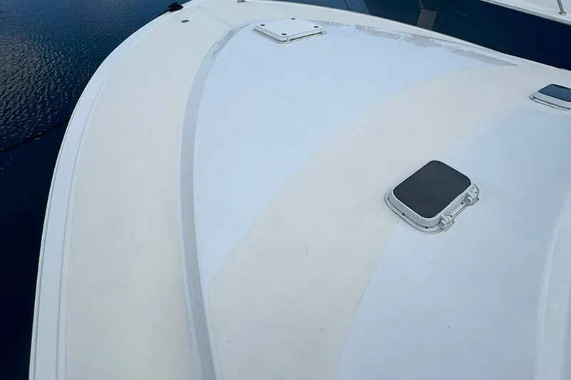 Slide: The Image of 1997 Ocean Yachts 48 Super Sport boat deck with hatches, on calm water. - 25