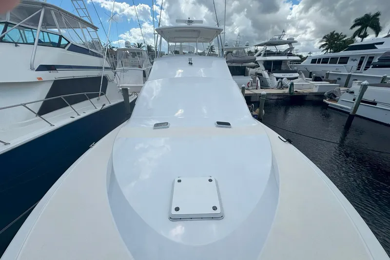 Slide: The Image of 1997 Ocean Yachts 48 Super Sport docked at marina under cloudy sky. - 26