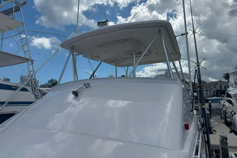 Slide: The Image of 1997 Ocean Yachts 48 Super Sport boat docked under cloudy sky. - 27