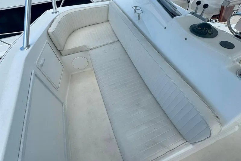 Slide: The Image of 1997 Ocean Yachts 48 Super Sport boat seating area with white cushioned bench. - 30