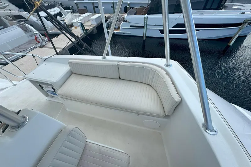 Slide: The Image of 1997 Ocean Yachts 48 Super Sport boat interior with white cushioned seating. - 31