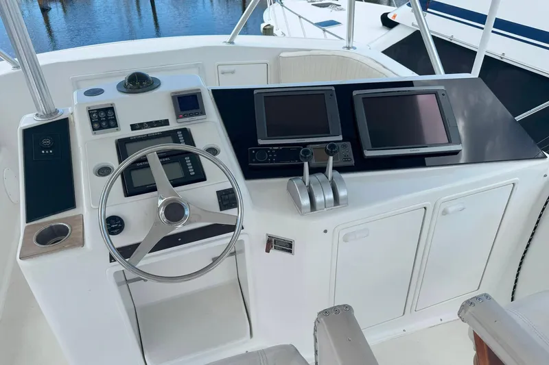 Slide: The Image of Cockpit of 1997 Ocean Yachts 48 Super Sport with steering wheel and navigation screens. - 34