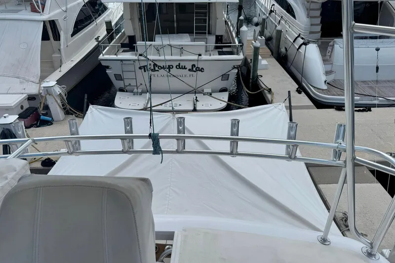 Slide: The Image of 1997 Ocean Yachts 48 Super Sport docked among other boats at a marina. - 37