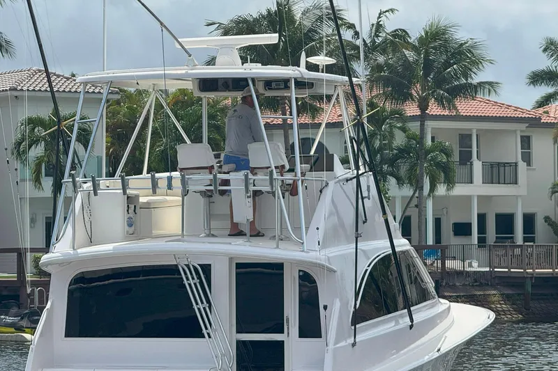 Slide: The Image of 1997 Ocean Yachts 48 Super Sport docked near waterfront homes with palm trees. - 38
