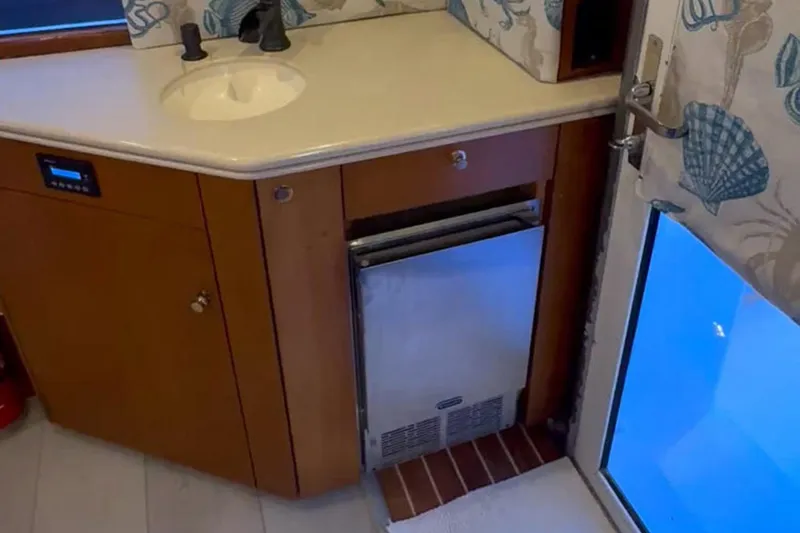 Slide: The Image of Interior of 1997 Ocean Yachts 48 Super Sport with sink and compact fridge. - 4