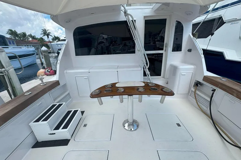 Slide: The Image of 1997 Ocean Yachts 48 Super Sport cockpit with fishing rod holders and seating area. - 41
