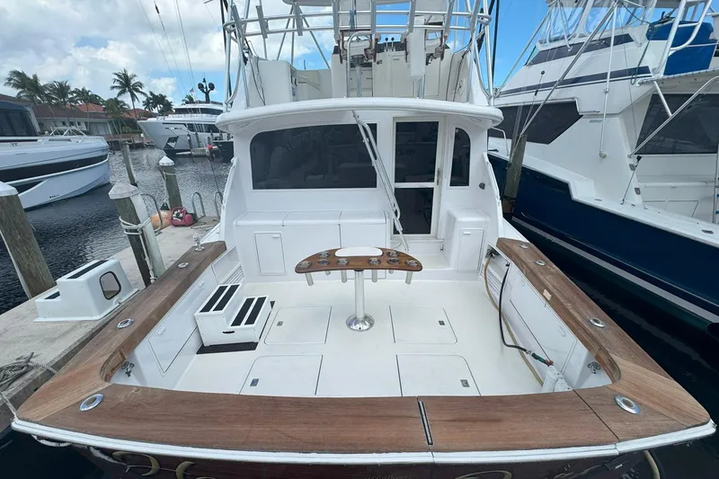 Slide: The Image of 1997 Ocean Yachts 48 Super Sport docked, featuring spacious deck and fishing setup. - 44