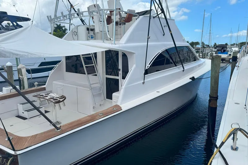 Slide: The Image of 1997 Ocean Yachts 48 Super Sport docked at marina under blue sky. - 45