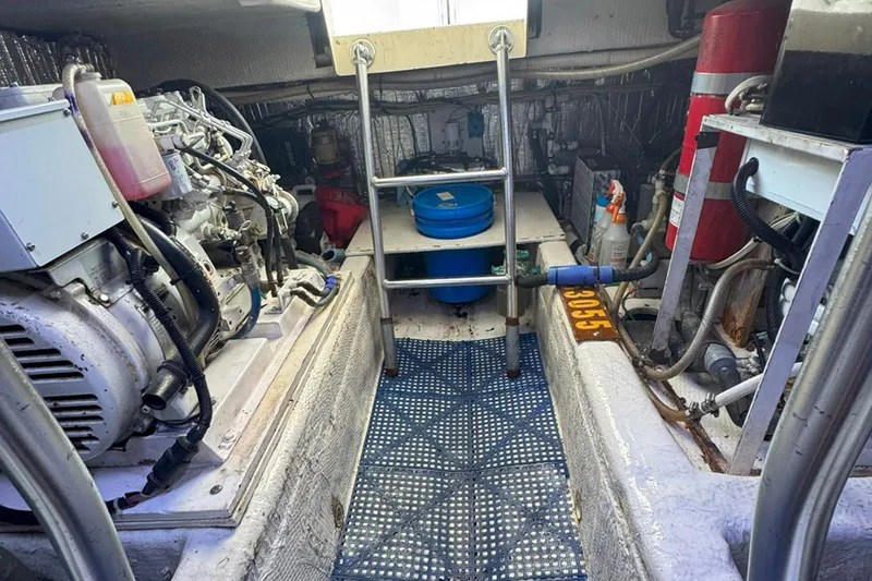 Slide: The Image of Engine room of a 1997 Ocean Yachts 48 Super Sport, featuring machinery and equipment. - 48