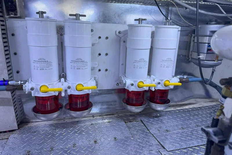 Slide: The Image of Engine room of 1997 Ocean Yachts 48 Super Sport with fuel filters and piping. - 49