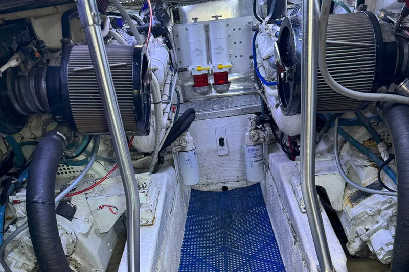 Slide: The Image of Engine room of 1997 Ocean Yachts 48 Super Sport, showcasing dual engines and components. - 50