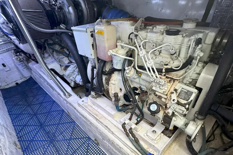 Slide: The Image of Engine room of 1997 Ocean Yachts 48 Super Sport, showcasing detailed machinery components. - 52