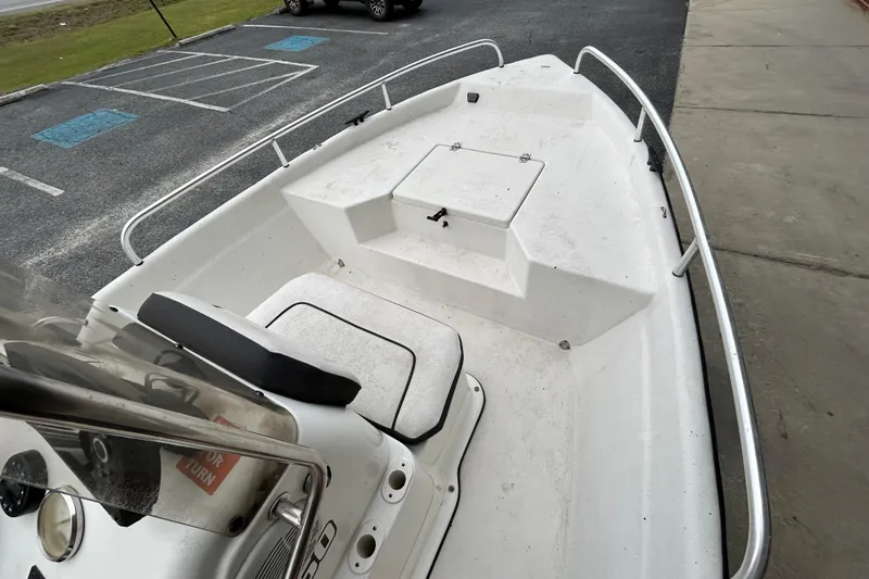 Slide: The Image of 2019 Cape Craft 160cc boat interior with seating and storage, parked on pavement. - 9