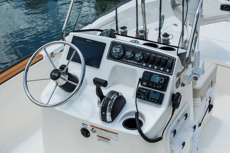 Slide: The Image of Manufacturer Provided Image: 2026 Boston Whaler 170 Montauk boat console with steering wheel and navigation instruments. - 17