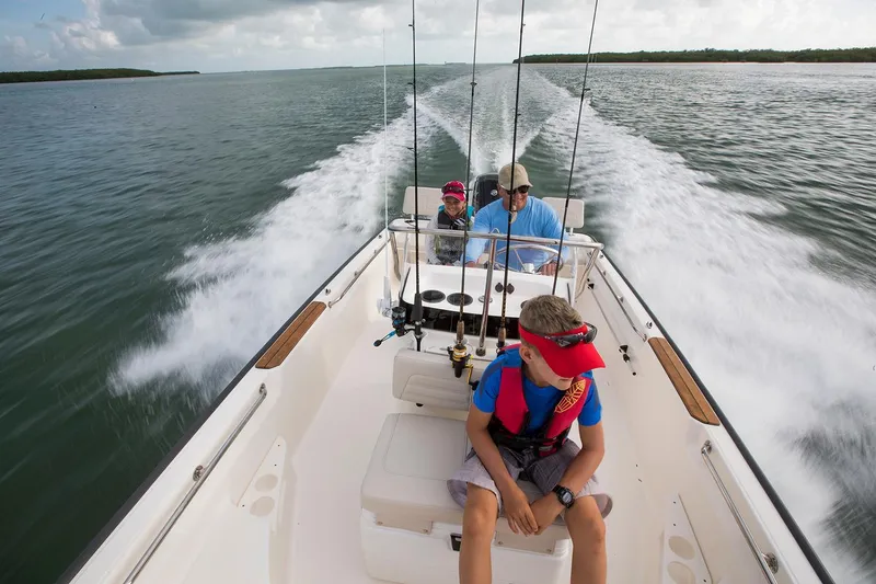 Slide: The Image of Manufacturer Provided Image: 2026 Boston Whaler 170 Montauk boat cruising with passengers on a sunny day. - 6