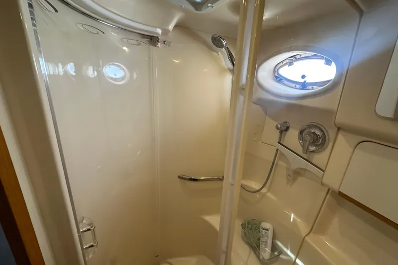Slide: The Image of Shower area in 1998 Sea Ray 450 Sundancer yacht with porthole and fixtures. - 12