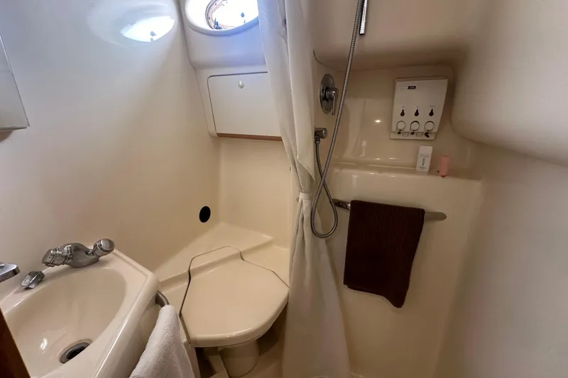 Slide: The Image of Bathroom interior of 1998 Sea Ray 450 Sundancer yacht, featuring sink and shower. - 16