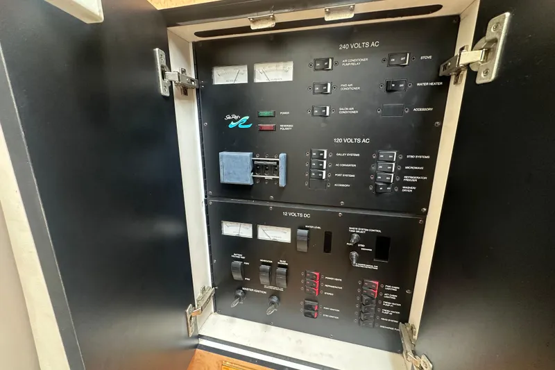 Slide: The Image of Electrical control panel of a 1998 Sea Ray 450 Sundancer yacht, featuring various switches and meters. - 17