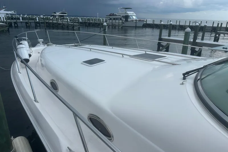 Slide: The Image of 1998 Sea Ray 450 Sundancer yacht docked at marina under cloudy sky. - 18